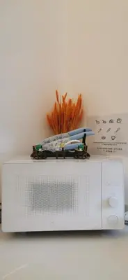 a toy train is on top of a microwave at Urban Suites - Dolphin's Home in Jelutong
