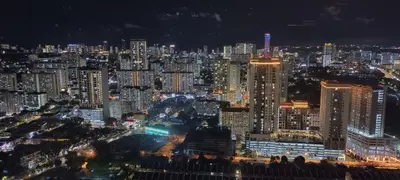 a night view of a large city with lit buildings at Urban Suites - Dolphin's Home in Jelutong