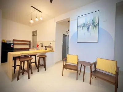 a kitchen with a dining room table and chairs at Jc Homestay in Ipoh