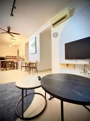a living room with a table and a dining room at Jc Homestay in Ipoh
