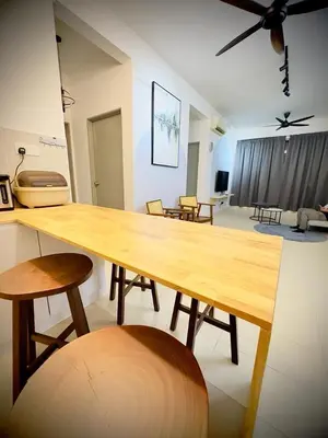 a living room with a wooden table and chairs at Jc Homestay in Ipoh