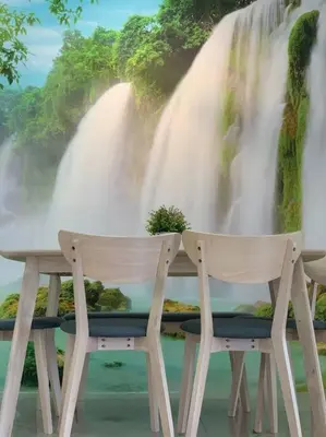 two chairs sitting at a table in front of a waterfall at Modern Lux Suite, The Cove Hillside Residence in Ipoh