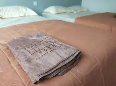 a towel is sitting on top of a bed at Evening/Night de Ville-50pax Private Pool BBQ in Ipoh