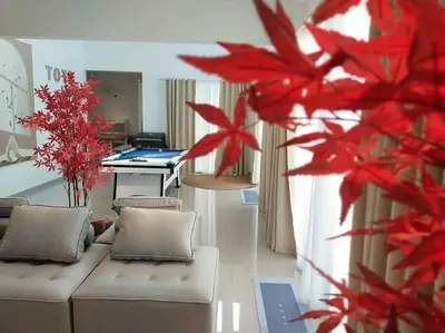 a living room with a couch and a table at Evening/Night de Ville-50pax Private Pool BBQ in Ipoh