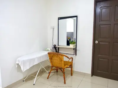 a dressing table and a chair in a room with a mirror at Ipoh Cozy Homestay for 10-13pax in Ipoh