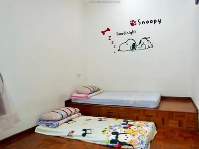 two twin beds in a room with a sticker on the wall at Ipoh Cozy Homestay for 10-13pax in Ipoh