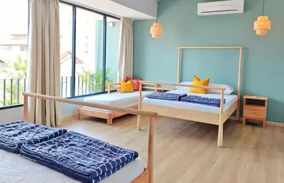 a bedroom with two beds and a large window at 35 BeachHouse Batu Ferringhi 7 Bedroom 7 Bathroom EV friendly in Batu Ferringhi