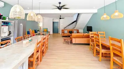 a dining room with a long table and chairs at 35 BeachHouse Batu Ferringhi 7 Bedroom 7 Bathroom EV friendly in Batu Ferringhi