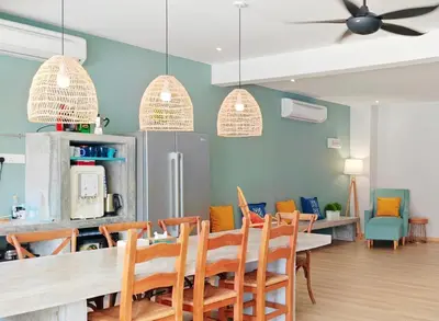 a dining room with a table and chairs at 35 BeachHouse Batu Ferringhi 7 Bedroom 7 Bathroom EV friendly in Batu Ferringhi