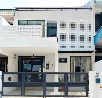 a white house with a blue fence at 35 BeachHouse Batu Ferringhi 7 Bedroom 7 Bathroom EV friendly in Batu Ferringhi