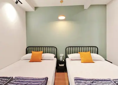 two beds sitting next to each other in a room at 35 BeachHouse Batu Ferringhi 7 Bedroom 7 Bathroom EV friendly in Batu Ferringhi