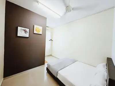 a bedroom with a white bed and a brown wall at 38 Georgetown 3 Storey Terrace local food 5rooms 16pax in George Town