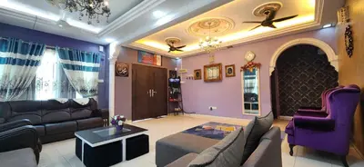 a living room with a couch and a table at Humayyah Homestay in Sungai Besar
