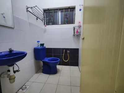 a bathroom with a blue toilet and a sink at Humayyah Homestay in Sungai Besar