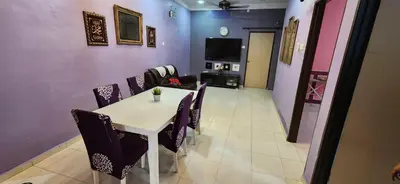 a dining room with a table and chairs and a tv at Humayyah Homestay in Sungai Besar