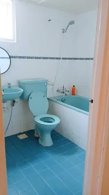 a bathroom with a blue toilet and a sink at Silverpart Resort Fraser Hill C3-6-2 Forest View High Floor No lift in Bukit Fraser