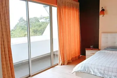 a bedroom with a bed and a large window at Silverpart Resort Fraser Hill C3-6-2 Forest View High Floor No lift in Bukit Fraser