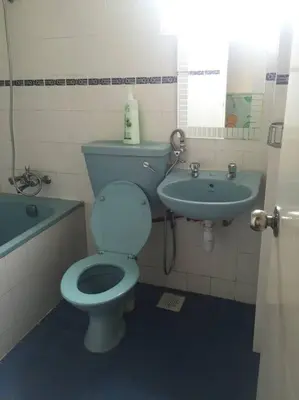 a bathroom with a blue toilet and a sink at Silverpart Resort Fraser Hill C3-6-1 Forest View High Floor No lift in Bukit Fraser