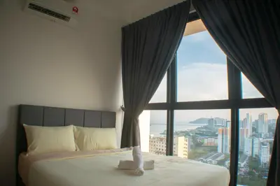 a bed in a room with a large window at Prime Comfort Seaview with Netflix and Water Filter near Georgetown in Jelutong