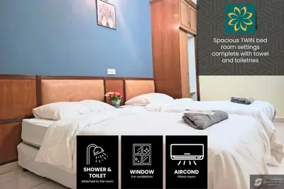 two beds in a room with signs on them at Thara Beach Resort in Pasir Bogak