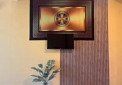 a wall with a picture and a plate on it at Thara Beach Resort in Pasir Bogak