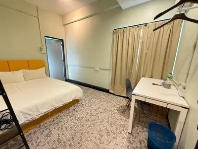 a room with a bed and a desk and a bed and a desk at 85 Boutique Hotel in Ipoh