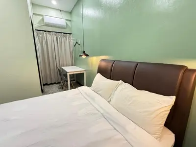 a bedroom with a bed and a table with a lamp at 85 Boutique Hotel in Ipoh