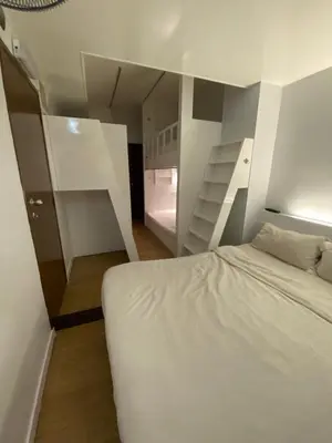 a bedroom with a white bed and a staircase at Suria Cameron Hotel in Tanah Rata