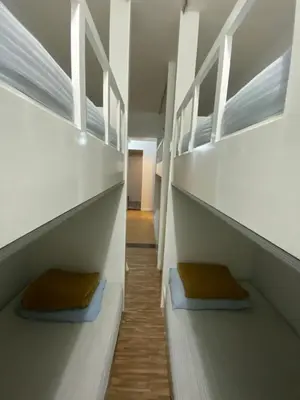 a room with two bunk beds and a hallway at Suria Cameron Hotel in Tanah Rata