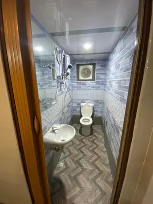 a small bathroom with a toilet and a sink at Suria Cameron Hotel in Tanah Rata