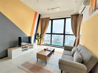 a living room with a couch and a television at Cityscape Suite, 4 to 5 Pax at Urban Suites Georgetown by SuperStay in Jelutong