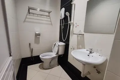a bathroom with a toilet and a sink at Hotel Kuang Hua Sitiawan Near To UniKL-MIMET in Sitiawan