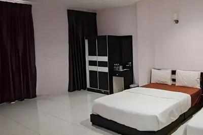 a bedroom with a large bed and black curtains at Hotel Kuang Hua Sitiawan Near To UniKL-MIMET in Sitiawan