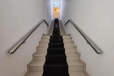 a stairway with black and white stairs in a building at Hotel Kuang Hua Sitiawan Near To UniKL-MIMET in Sitiawan