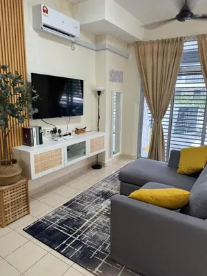 a living room with a couch and a flat screen tv at Orked Homestay Bagan Serai in Bagan Serai