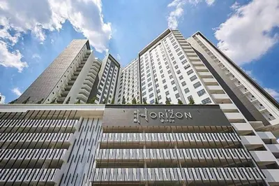 a tall building with a sign on the front of it at Cozy Homestay \u6e29\u99a8\u6c11\u5bbf @The Horizon Ipoh\u516c\u5bd3\u65e0\u8fb9\u6cf3\u6c60 (6-10\u4eba\uff09 in Ipoh
