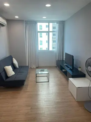 a living room with a black couch and a tv at Georgetown ins cozy 2 bedroom in George Town
