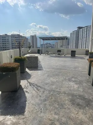 a rooftop with a picnic shelter on a building at Georgetown ins cozy 2 bedroom in George Town