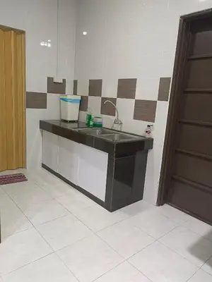 a kitchen counter with a sink in a room at 8Pax comfortable setia residen in Sitiawan