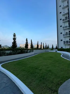 a grassy area in front of a building at The Horizon Ipoh Blissful Homestay 2 in Ipoh