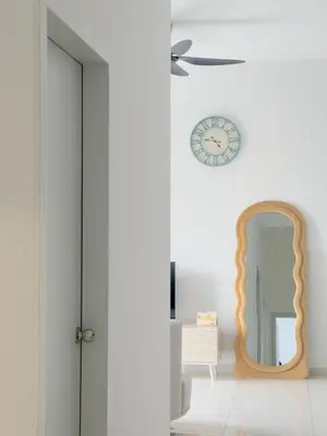 a room with a mirror and a clock on the wall at The Horizon Ipoh Blissful Homestay 2 in Ipoh
