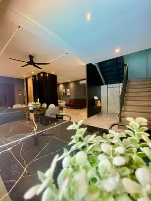 a living room with a ceiling fan and a staircase at LYL Jaccuzi Private Pool House - 16PAX in Ipoh