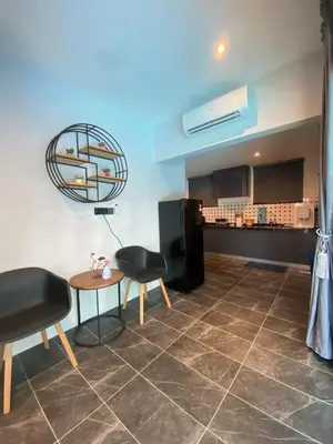 a room with a table and two chairs and a kitchen at LYL Jaccuzi Private Pool House - 16PAX in Ipoh