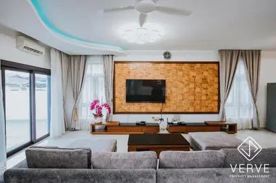 a living room with a couch and a flat screen tv at Ipoh Garden Luxury House By Verve (14pax) in Ipoh