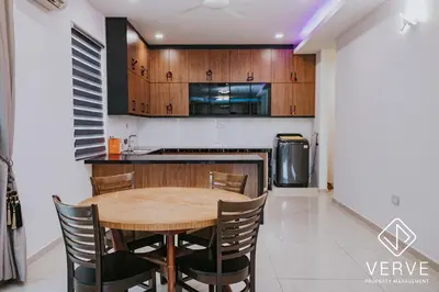 a kitchen and dining room with a wooden table and chairs at Ipoh Garden Luxury House By Verve (14pax) in Ipoh