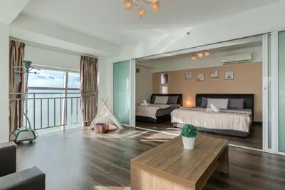 a large bedroom with a bed and a balcony at Maritime Seaview Comfy Suite Penang with TVbox,Pool,Freewifi,2-8pax in Jelutong