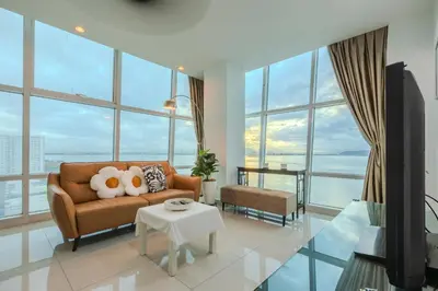 a living room with a couch and a table at Maritime Seaview Comfy Suite Penang with TVbox,Pool,Freewifi,2-8pax in Jelutong