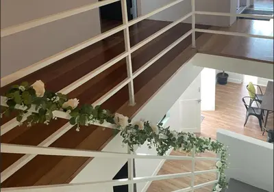 a stairway with a flower arrangement on it at Modern Victorian Homestay in Jelutong