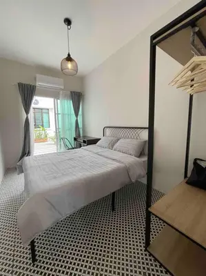 a bedroom with a large bed and a mirror at Modern Victorian Homestay in Jelutong