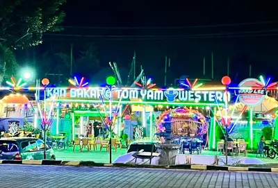 a night view of a carnival with neon lights at Sunway Alpine Suites near Onsen and Themepark Tambun Ipoh by IWH in Ipoh